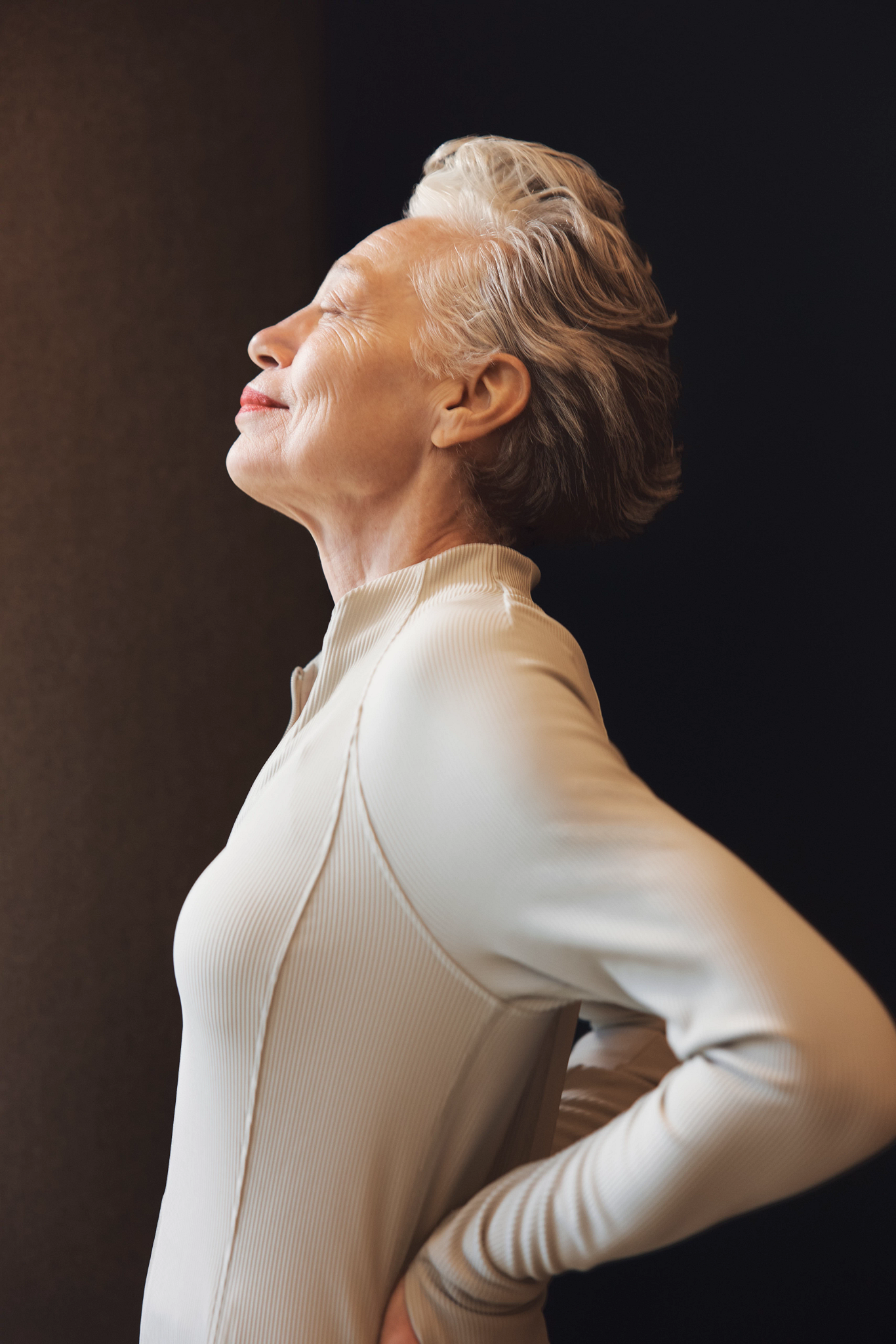 Portrait of a mature female calmly standing with her eyes closed taking in a breath